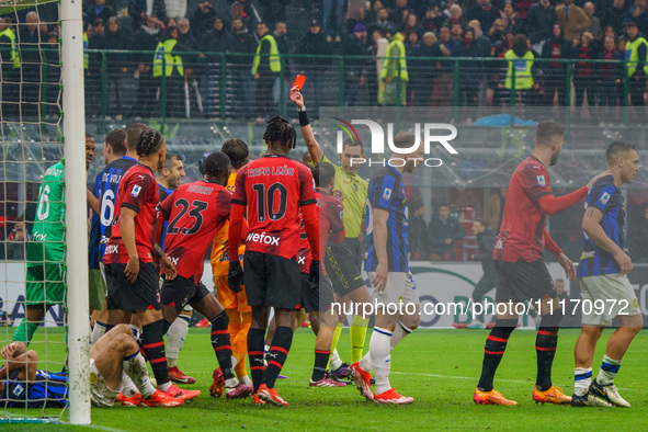 Referee Andrea Colombo is showing the red card to Davide Calabria during the AC Milan versus FC Internazionale match in Serie A at Giuseppe...