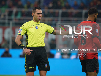 Referee Andrea Colombo is officiating the match between AC Milan and FC Internazionale in the Serie A at Giuseppe Meazza Stadium on April 22...