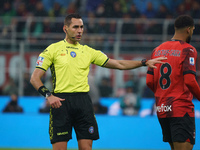 Referee Andrea Colombo is officiating the match between AC Milan and FC Internazionale in the Serie A at Giuseppe Meazza Stadium on April 22...