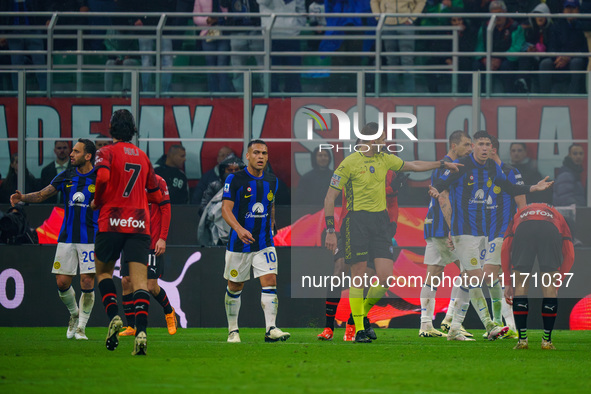 Referee Andrea Colombo is officiating the match between AC Milan and FC Internazionale in the Serie A at Giuseppe Meazza Stadium on April 22...