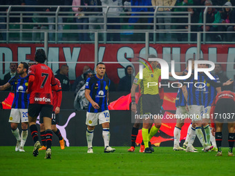 Referee Andrea Colombo is officiating the match between AC Milan and FC Internazionale in the Serie A at Giuseppe Meazza Stadium on April 22...