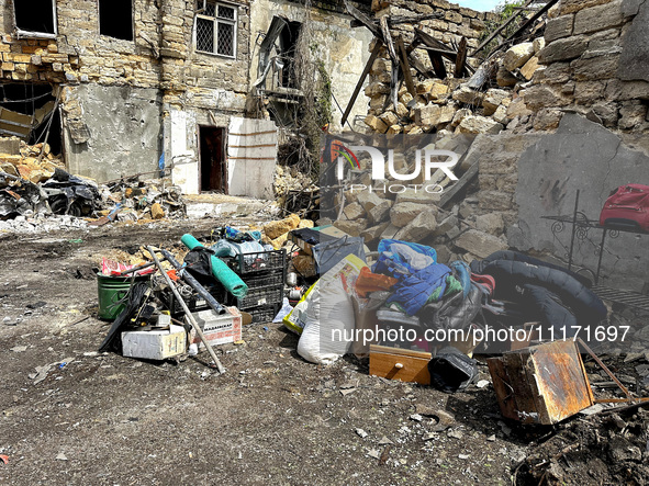 Personal belongings are being piled outside a residential building that has been damaged by a nighttime Russian drone attack in Odesa, Ukrai...