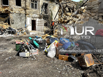 Personal belongings are being piled outside a residential building that has been damaged by a nighttime Russian drone attack in Odesa, Ukrai...