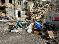 Personal belongings are being piled outside a residential building that has been damaged by a nighttime Russian drone attack in Odesa, Ukrai...