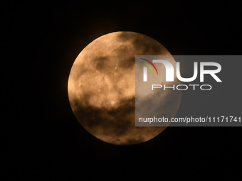 The 'Pink Moon,' which is April's full Moon, is being seen from Nagaon District, Assam, India, on April 23, 2024. (