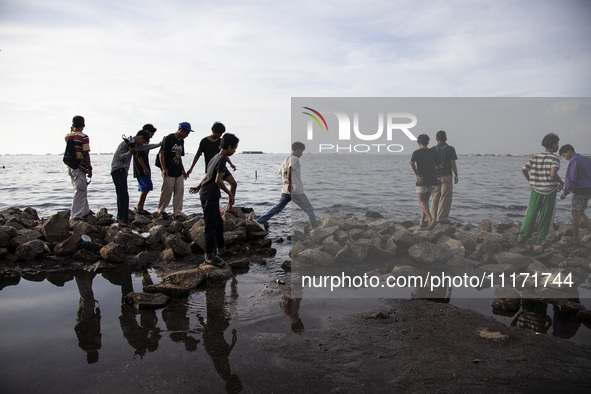 People are enjoying their holiday at Marunda public beach on the north coast of Jakarta, Indonesia, on April 23, 2024. Marunda Beach is the...