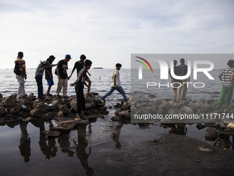 People are enjoying their holiday at Marunda public beach on the north coast of Jakarta, Indonesia, on April 23, 2024. Marunda Beach is the...