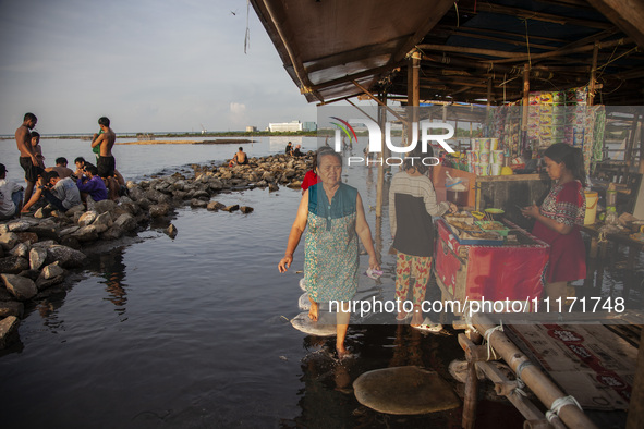 People are enjoying their holiday at Marunda public beach on the north coast of Jakarta, Indonesia, on April 23, 2024. Marunda Beach is the...