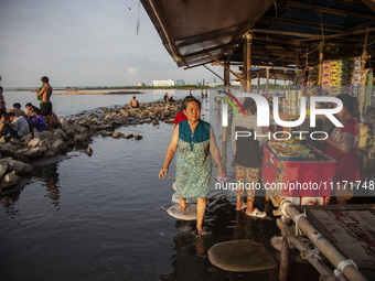 People are enjoying their holiday at Marunda public beach on the north coast of Jakarta, Indonesia, on April 23, 2024. Marunda Beach is the...