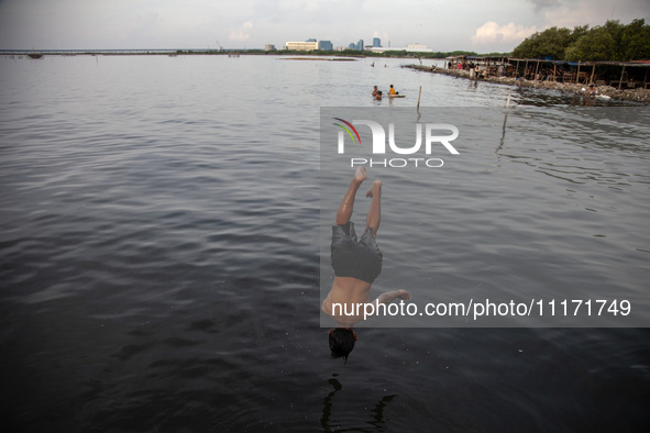 People are enjoying their holiday at Marunda public beach on the north coast of Jakarta, Indonesia, on April 23, 2024. Marunda Beach is the...