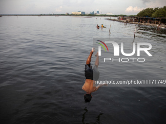 People are enjoying their holiday at Marunda public beach on the north coast of Jakarta, Indonesia, on April 23, 2024. Marunda Beach is the...