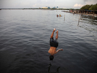 People are enjoying their holiday at Marunda public beach on the north coast of Jakarta, Indonesia, on April 23, 2024. Marunda Beach is the...