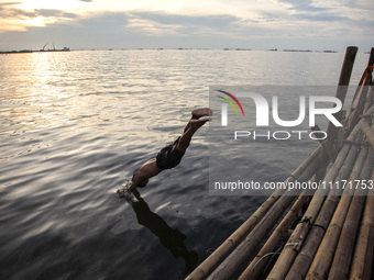 People are enjoying their holiday at Marunda public beach on the north coast of Jakarta, Indonesia, on April 23, 2024. Marunda Beach is the...