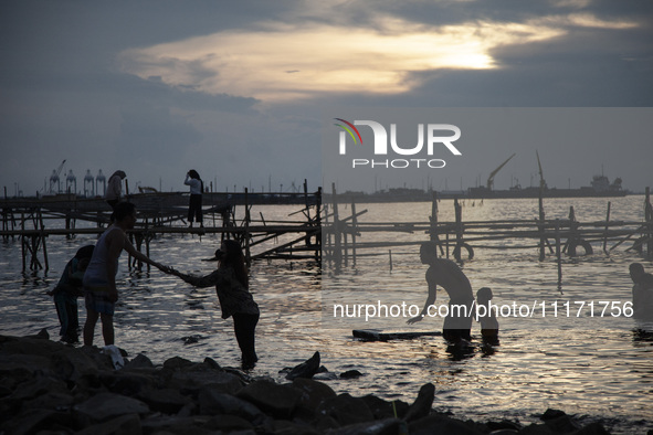 People are enjoying their holiday at Marunda public beach on the north coast of Jakarta, Indonesia, on April 23, 2024. Marunda Beach is the...