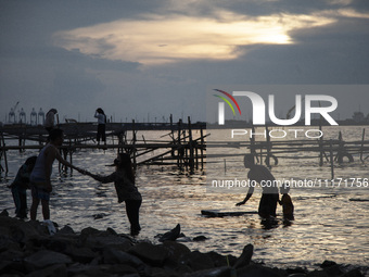 People are enjoying their holiday at Marunda public beach on the north coast of Jakarta, Indonesia, on April 23, 2024. Marunda Beach is the...