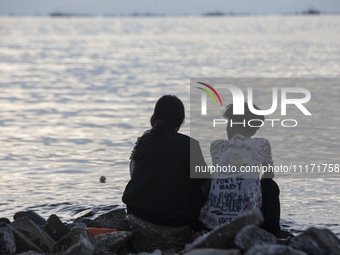 People are enjoying their holiday at Marunda public beach on the north coast of Jakarta, Indonesia, on April 23, 2024. Marunda Beach is the...