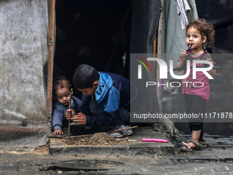 Displaced Palestinian children are playing as they shelter in a UNRWA-affiliated school in Deir Al-Balah, in the central Gaza Strip, on Apri...