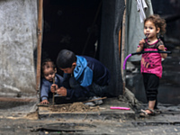 Displaced Palestinian children are playing as they shelter in a UNRWA-affiliated school in Deir Al-Balah, in the central Gaza Strip, on Apri...