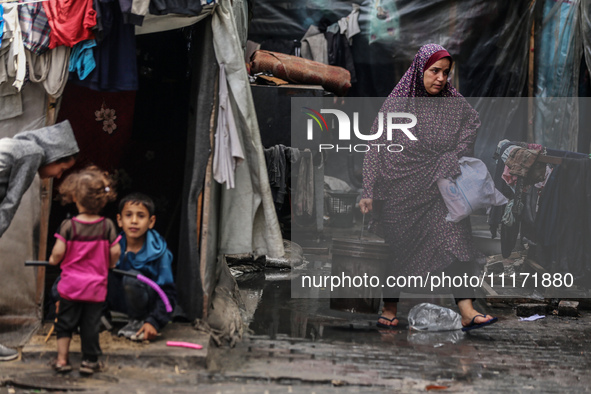 Displaced Palestinians are sheltering in a UNRWA-affiliated school after fleeing their homes due to Israeli strikes, amid the ongoing confli...