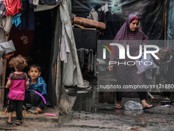 Displaced Palestinians are sheltering in a UNRWA-affiliated school after fleeing their homes due to Israeli strikes, amid the ongoing confli...