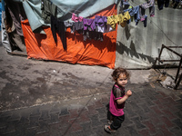 Displaced Palestinian children are playing as they shelter in a UNRWA-affiliated school in Deir Al-Balah, in the central Gaza Strip, on Apri...