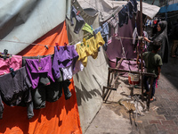 Displaced Palestinians are sheltering in a UNRWA-affiliated school after fleeing their homes due to Israeli strikes, amid the ongoing confli...