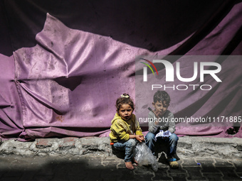 Displaced Palestinian children are playing as they shelter in a UNRWA-affiliated school in Deir Al-Balah, in the central Gaza Strip, on Apri...