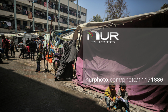 Displaced Palestinians are sheltering in a UNRWA-affiliated school after fleeing their homes due to Israeli strikes, amid the ongoing confli...