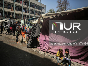 Displaced Palestinians are sheltering in a UNRWA-affiliated school after fleeing their homes due to Israeli strikes, amid the ongoing confli...