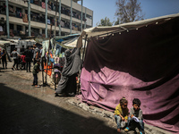 Displaced Palestinians are sheltering in a UNRWA-affiliated school after fleeing their homes due to Israeli strikes, amid the ongoing confli...