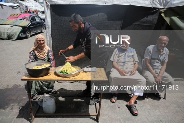 Displaced Palestinians are sheltering in a UNRWA-affiliated school after fleeing their homes due to Israeli strikes, amid the ongoing confli...