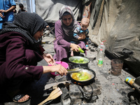 Displaced Palestinians are sheltering in a UNRWA-affiliated school after fleeing their homes due to Israeli strikes, amid the ongoing confli...