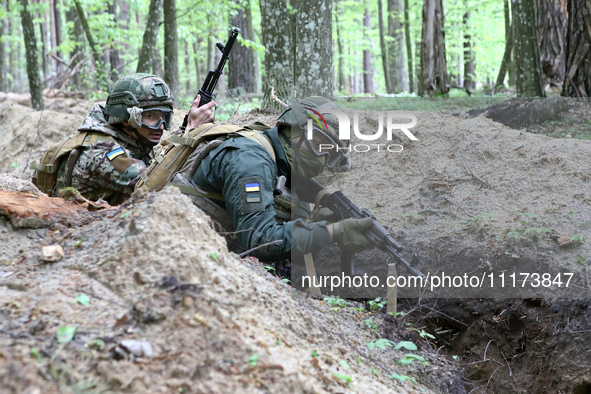 Soldiers are practicing clearing a trench from the enemy in pairs during the drills of the Liut (Fury) Brigade of the National Police of Ukr...