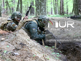 Soldiers are practicing clearing a trench from the enemy in pairs during the drills of the Liut (Fury) Brigade of the National Police of Ukr...