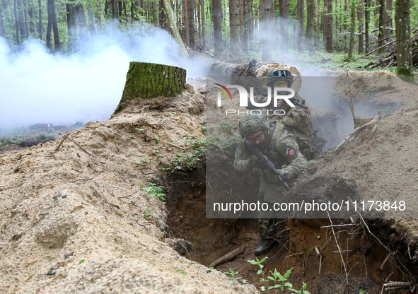 Soldiers are practicing clearing a trench from the enemy in pairs during the drills of the Liut (Fury) Brigade of the National Police of Ukr...