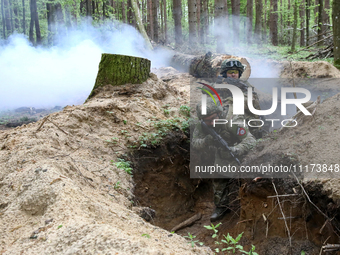 Soldiers are practicing clearing a trench from the enemy in pairs during the drills of the Liut (Fury) Brigade of the National Police of Ukr...