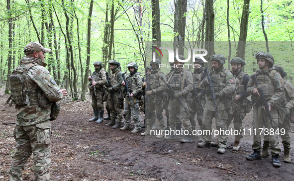 Soldiers are receiving instructions before the start of the drills of the Liut (Fury) Brigade of the National Police of Ukraine at a trainin...