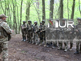 Soldiers are receiving instructions before the start of the drills of the Liut (Fury) Brigade of the National Police of Ukraine at a trainin...