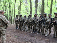 Soldiers are receiving instructions before the start of the drills of the Liut (Fury) Brigade of the National Police of Ukraine at a trainin...