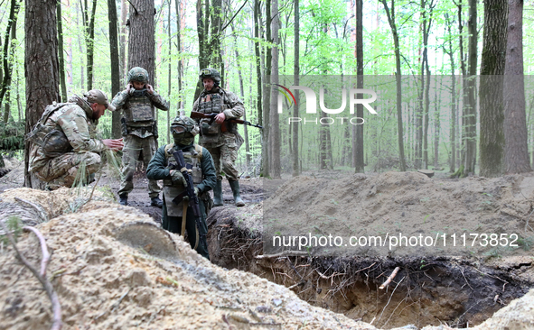 Soldiers are practicing clearing a trench from the enemy in pairs during the drills of the Liut (Fury) Brigade of the National Police of Ukr...