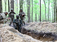 Soldiers are practicing clearing a trench from the enemy in pairs during the drills of the Liut (Fury) Brigade of the National Police of Ukr...