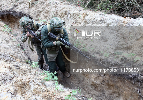 Soldiers are practicing clearing a trench from the enemy in pairs during the drills of the Liut (Fury) Brigade of the National Police of Ukr...