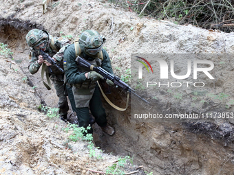 Soldiers are practicing clearing a trench from the enemy in pairs during the drills of the Liut (Fury) Brigade of the National Police of Ukr...