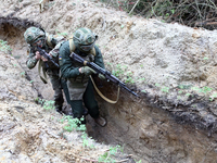 Soldiers are practicing clearing a trench from the enemy in pairs during the drills of the Liut (Fury) Brigade of the National Police of Ukr...