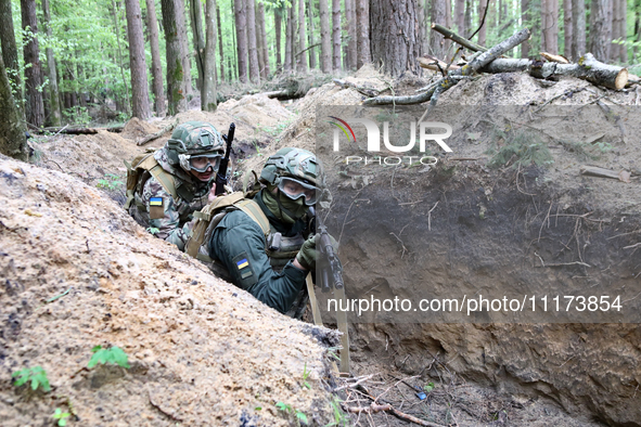 Soldiers are practicing clearing a trench from the enemy in pairs during the drills of the Liut (Fury) Brigade of the National Police of Ukr...