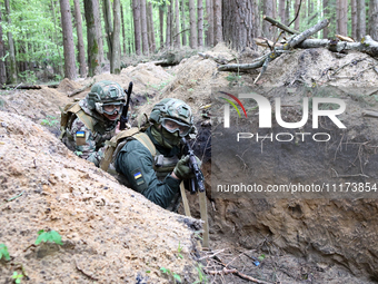 Soldiers are practicing clearing a trench from the enemy in pairs during the drills of the Liut (Fury) Brigade of the National Police of Ukr...