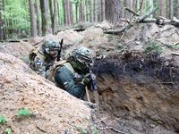 Soldiers are practicing clearing a trench from the enemy in pairs during the drills of the Liut (Fury) Brigade of the National Police of Ukr...