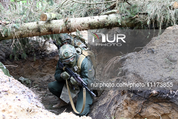 Soldiers are practicing clearing a trench from the enemy in pairs during the drills of the Liut (Fury) Brigade of the National Police of Ukr...