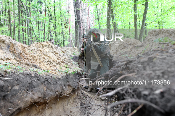 Soldiers are practicing clearing a trench from the enemy in pairs during the drills of the Liut (Fury) Brigade of the National Police of Ukr...