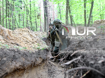 Soldiers are practicing clearing a trench from the enemy in pairs during the drills of the Liut (Fury) Brigade of the National Police of Ukr...